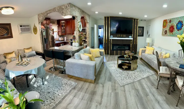 a living room with furniture fireplace and dining table