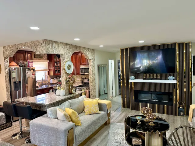 a living room with fireplace furniture and a flat screen tv