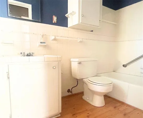 a white toilet sitting next to a bathroom sink