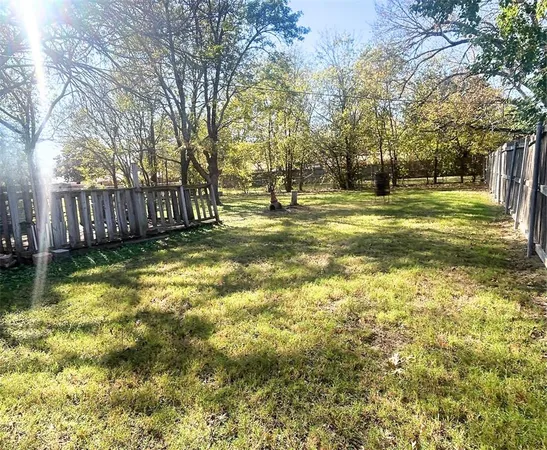 a view of yard with swimming pool and trees