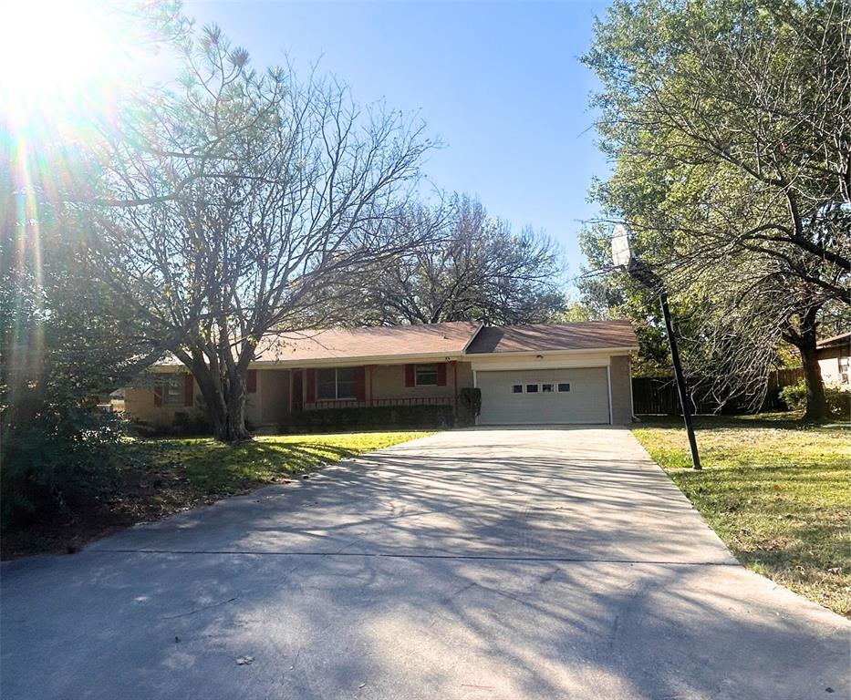 2609 Washington Street Commerce, TX 75428 - Photo 3 of 20 a house with trees in front of it