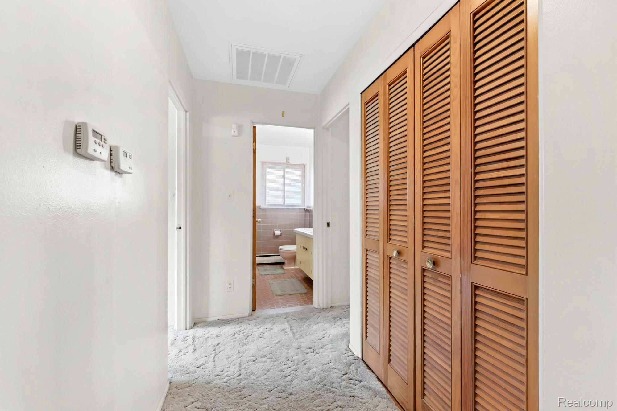 23410 Joy Road Redford, MI 48239 - Photo 19 of 25 Hall featuring light colored carpet and baseboard heating