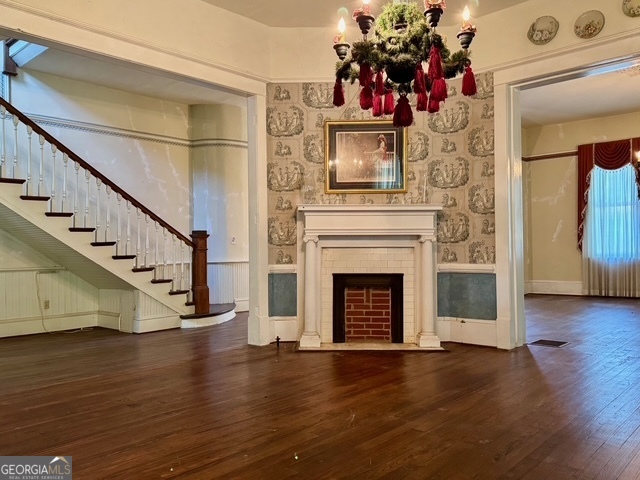 222 Church Street Lexington, GA 30648 - Photo 11 of 50 a view of a livingroom with fireplace wooden floor and staircase