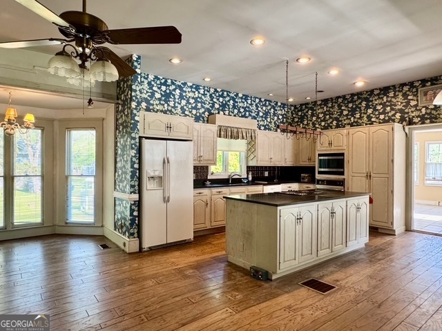 222 Church Street Lexington, GA 30648 - Photo 16 of 50 a kitchen with stainless steel appliances granite countertop a stove and a refrigerator