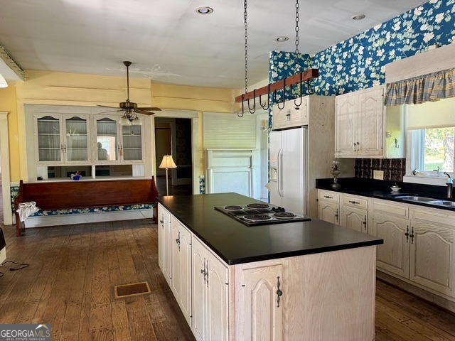 222 Church Street Lexington, GA 30648 - Photo 17 of 50 a kitchen with a stove and a chandelier
