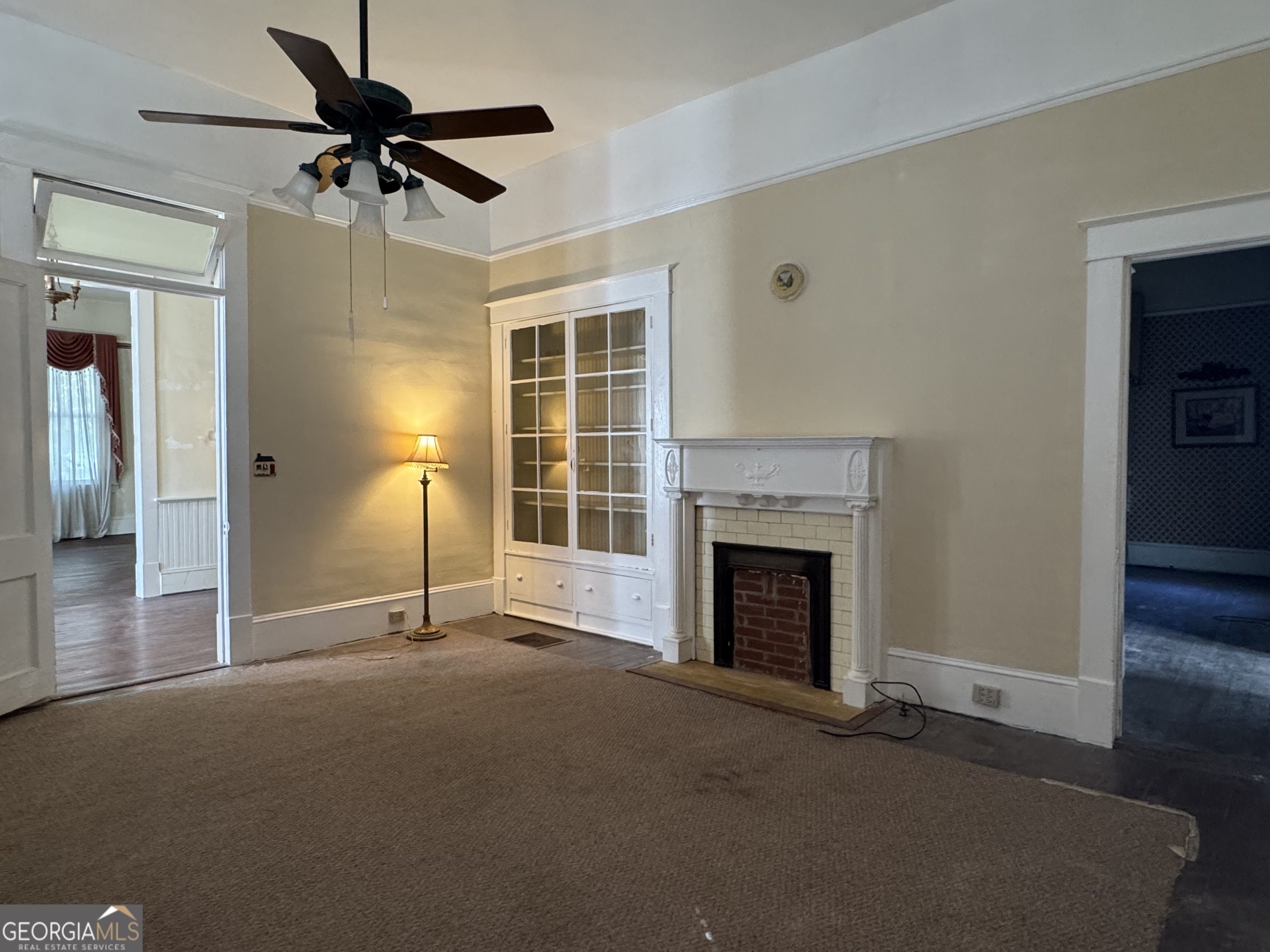 222 Church Street Lexington, GA 30648 - Photo 23 of 50 a view of a livingroom with a fireplace and a ceiling fan