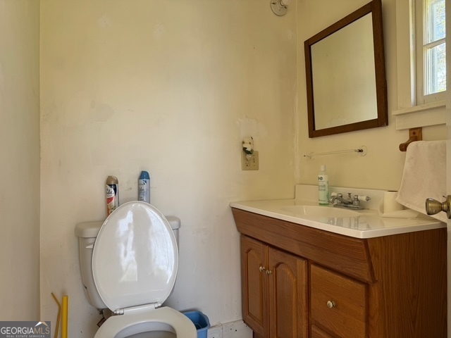 222 Church Street Lexington, GA 30648 - Photo 31 of 50 a bathroom with a toilet sink and mirror