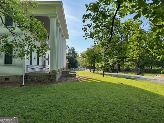 222 Church Street Lexington, GA 30648 - Photo 47 of 50 a view of a swimming pool with lawn chairs and a big yard