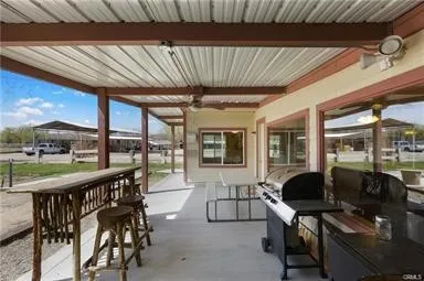 a view of a dining room with furniture a chandelier and wooden floor