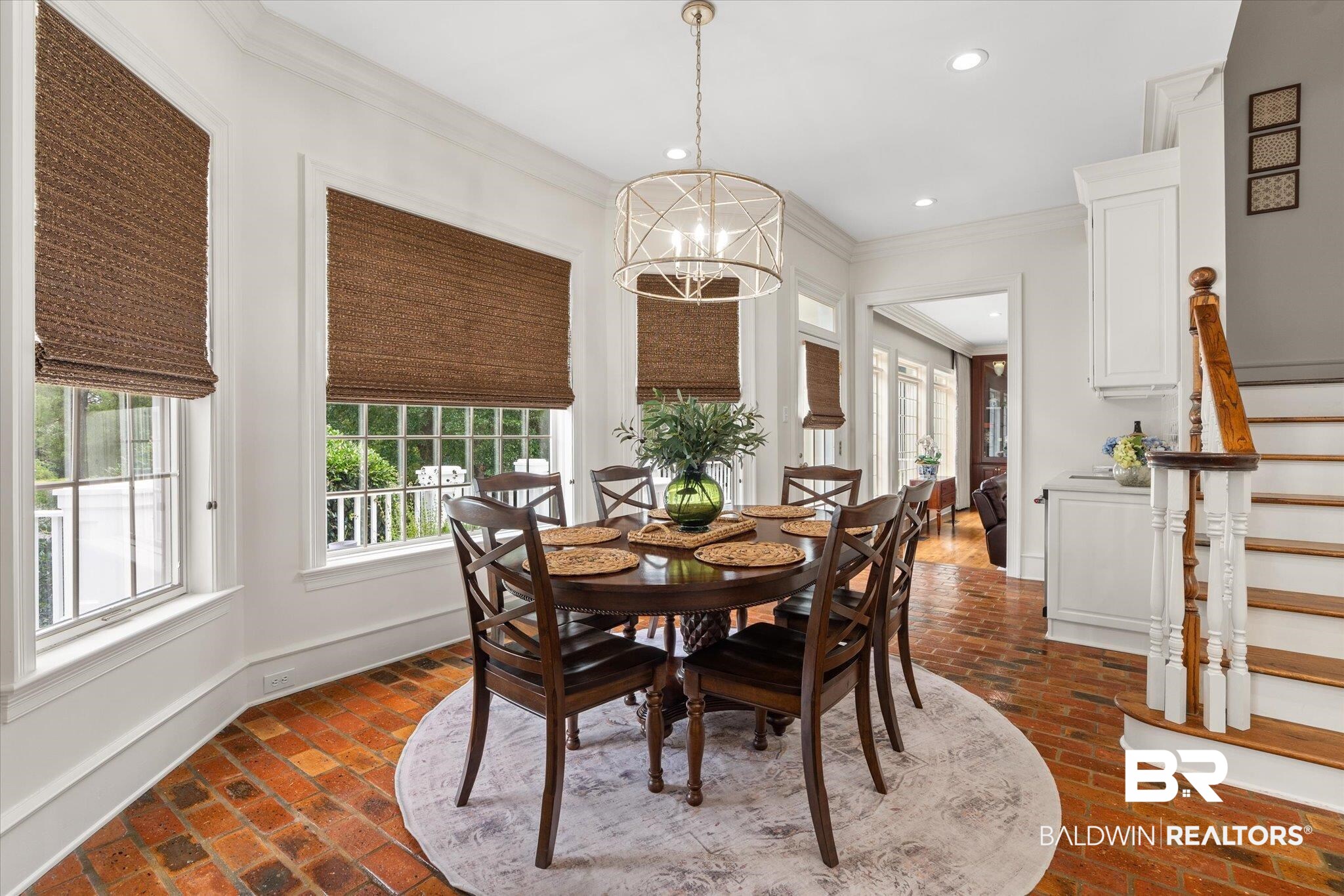 8561 Dawes Lake Road Mobile, AL 36619 - Photo 11 of 63 Dining room with brick flooring, ornamental molding, stairway, recessed lighting, and a chandelier