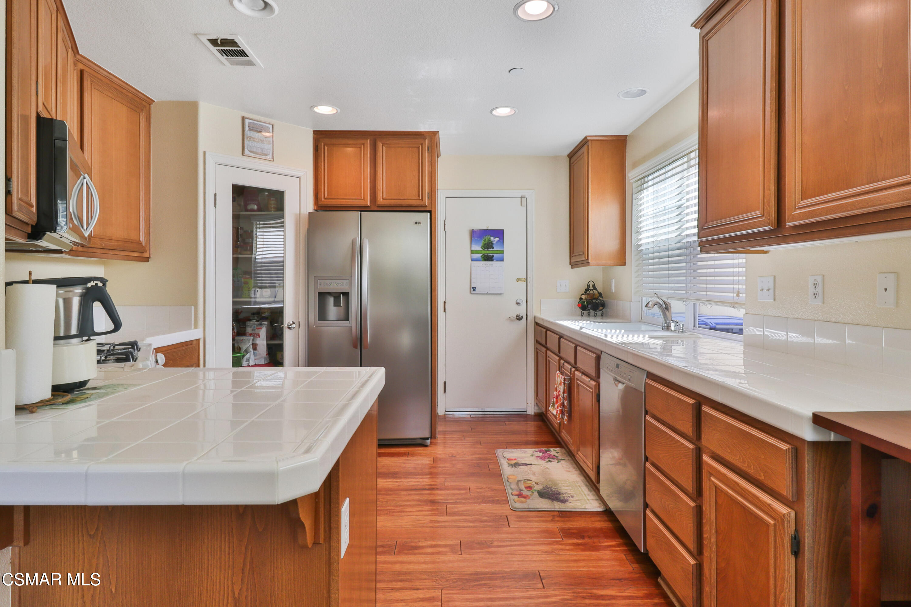 5281 Davidson Drive Oxnard, CA 93033 - Photo 15 of 38 a kitchen with stainless steel appliances granite countertop a sink and a refrigerator