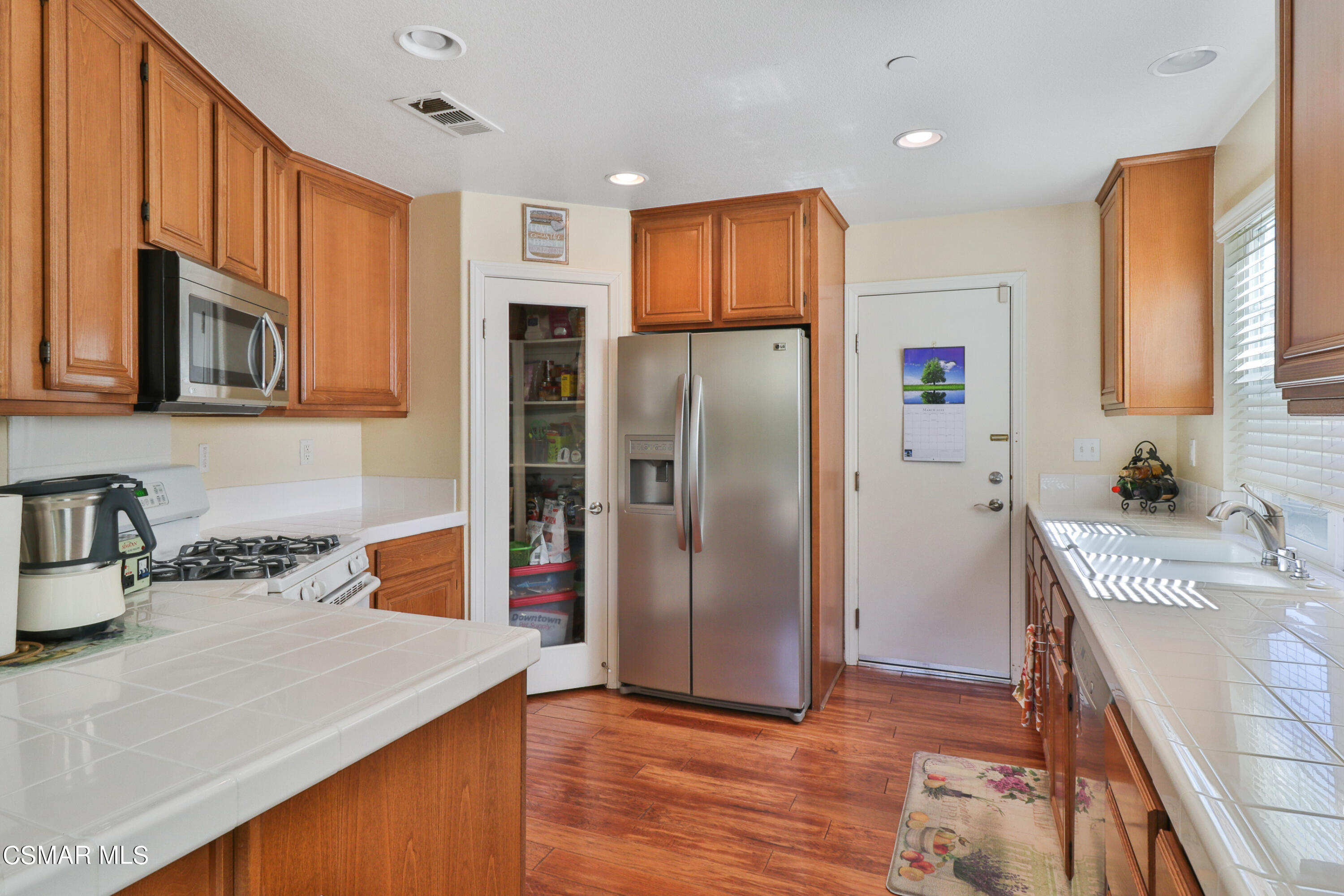 5281 Davidson Drive Oxnard, CA 93033 - Photo 17 of 38 a kitchen with stainless steel appliances granite countertop a refrigerator sink and microwave