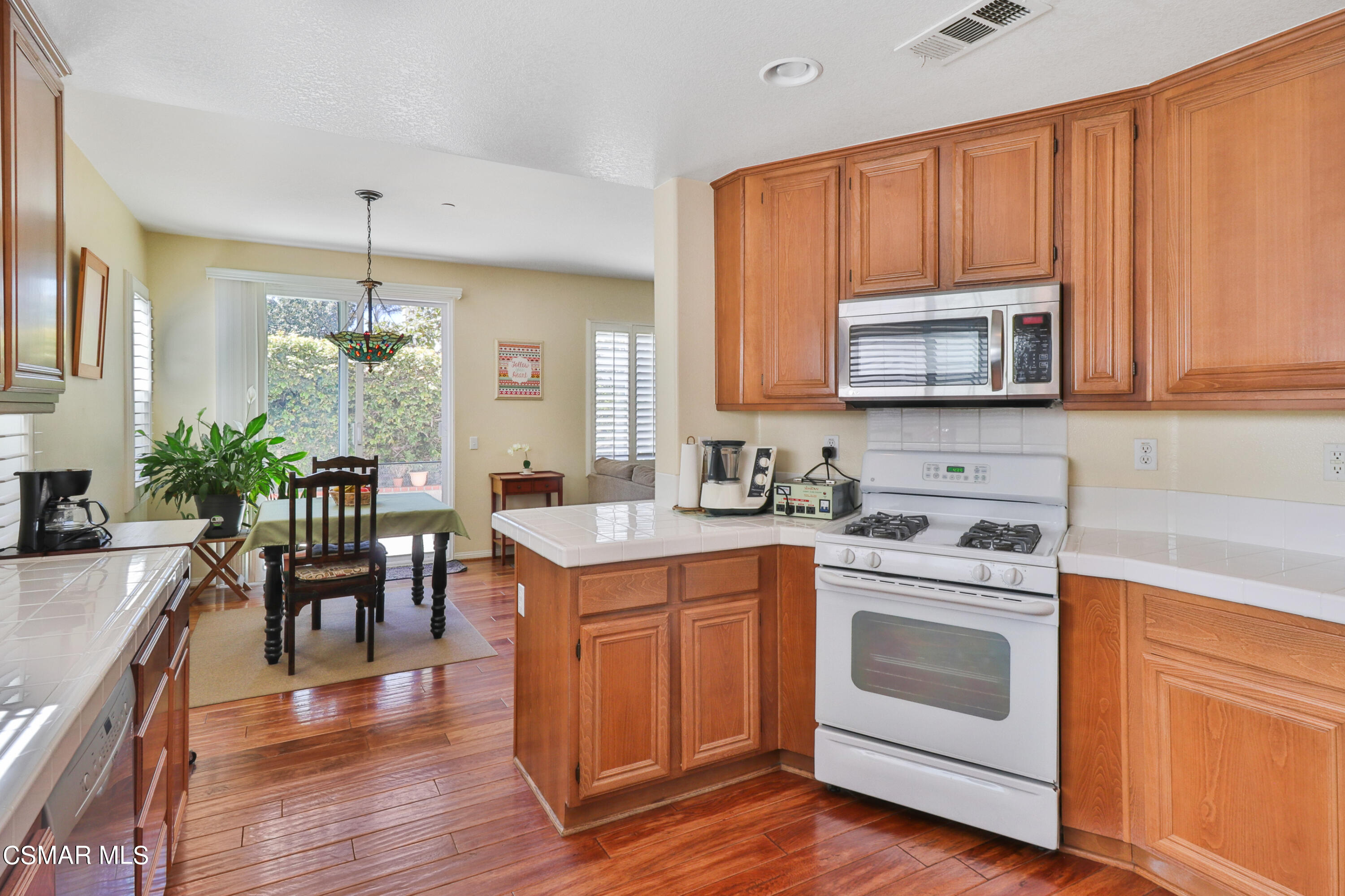 5281 Davidson Drive Oxnard, CA 93033 - Photo 18 of 38 a kitchen with a stove microwave and cabinets