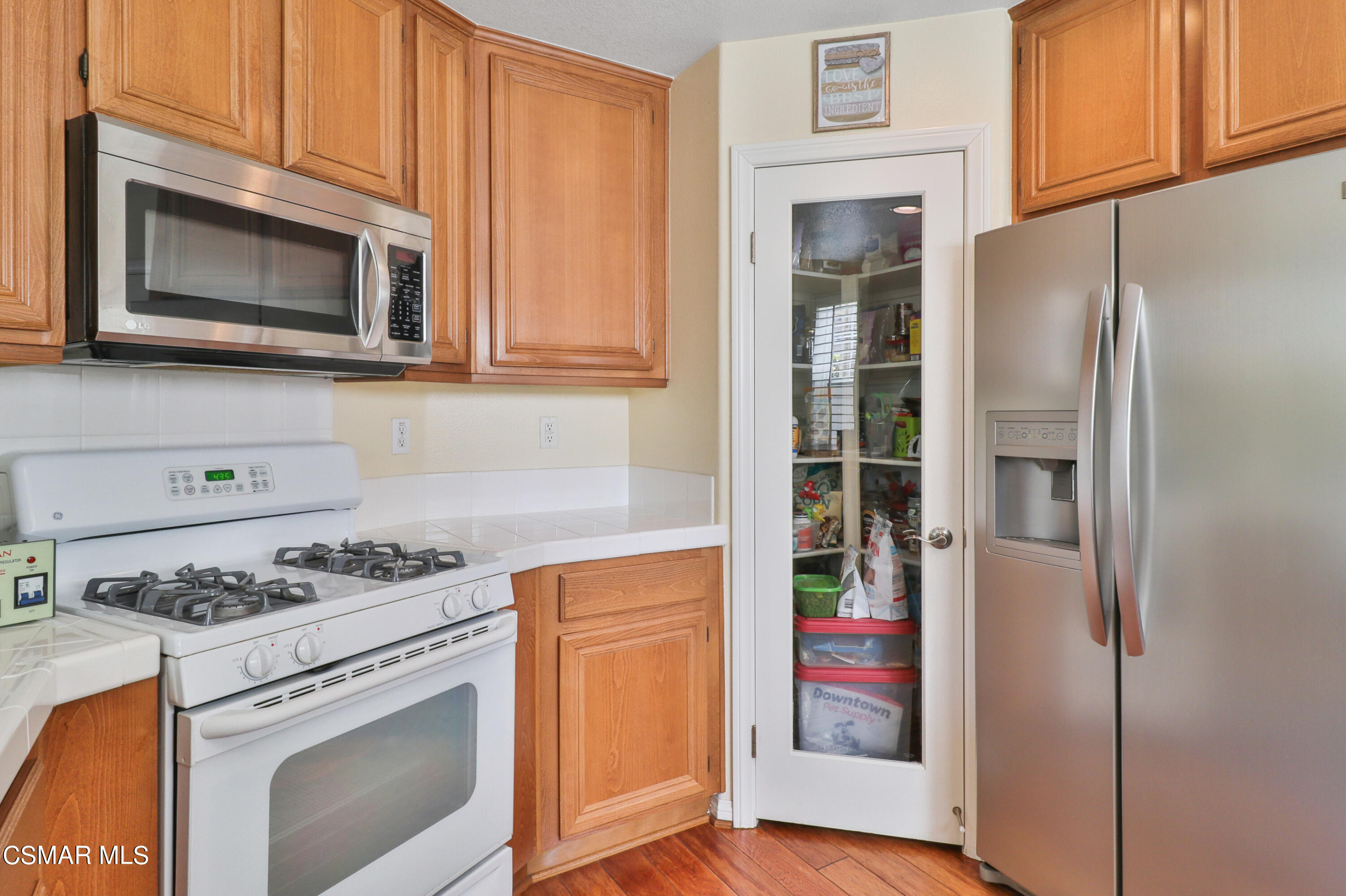 5281 Davidson Drive Oxnard, CA 93033 - Photo 20 of 38 a kitchen with stainless steel appliances granite countertop a stove microwave and refrigerator
