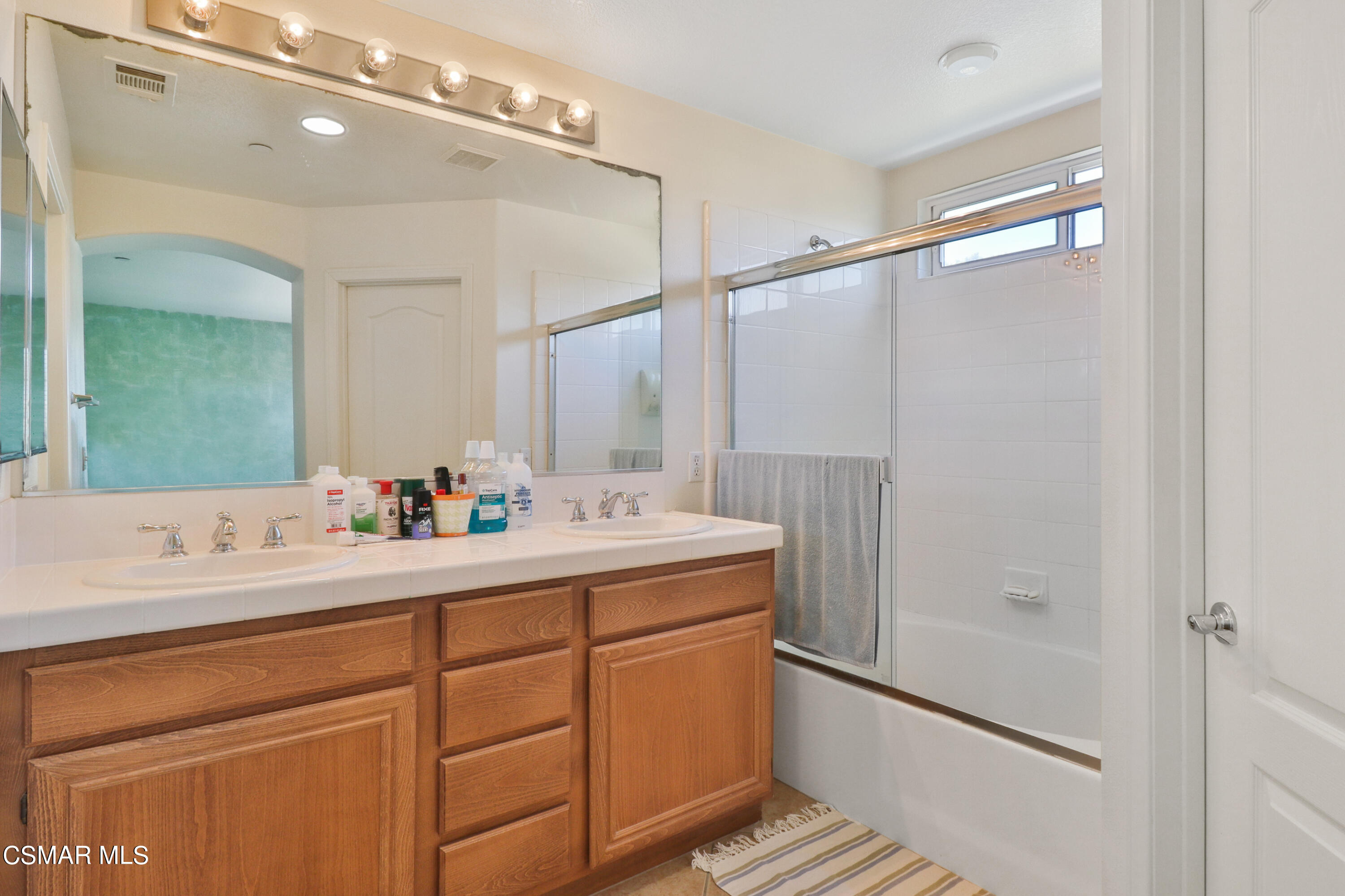 5281 Davidson Drive Oxnard, CA 93033 - Photo 24 of 38 a bathroom with a sink double vanity and a mirror