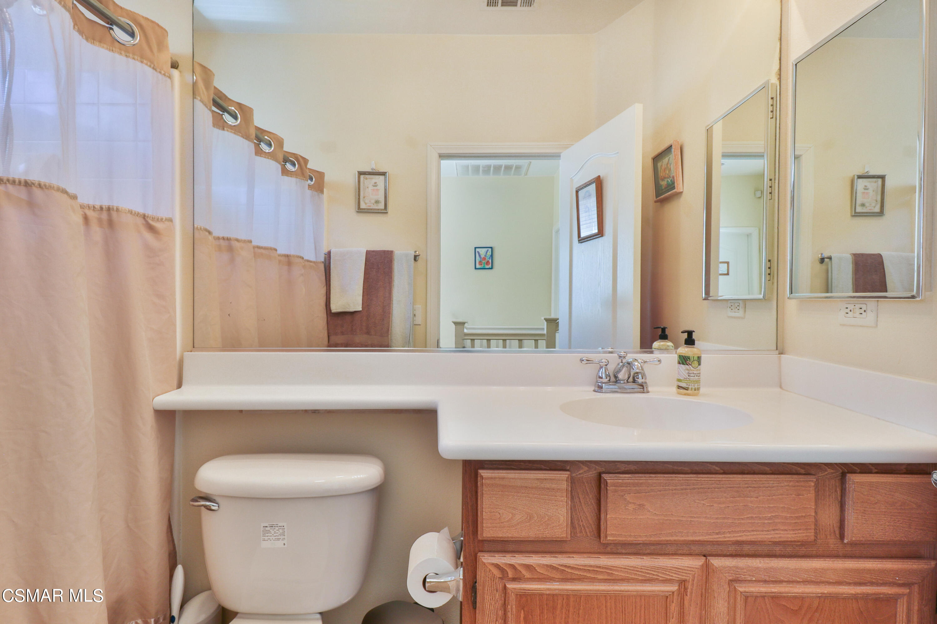 5281 Davidson Drive Oxnard, CA 93033 - Photo 28 of 38 a bathroom with a sink a toilet and a mirror