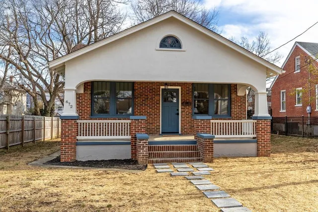 a view of a house with a yard and sitting area