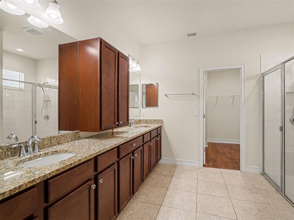 4429 Conchfish Lane Osprey, FL 34229 - Photo 10 of 20 a bathroom with a granite countertop sink and a mirror