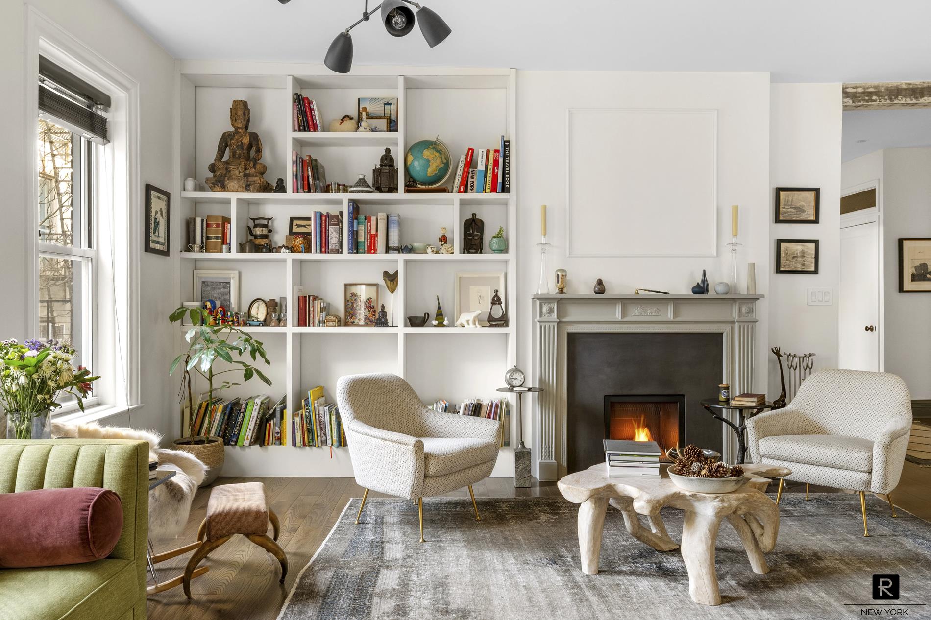a living room with furniture and a fireplace