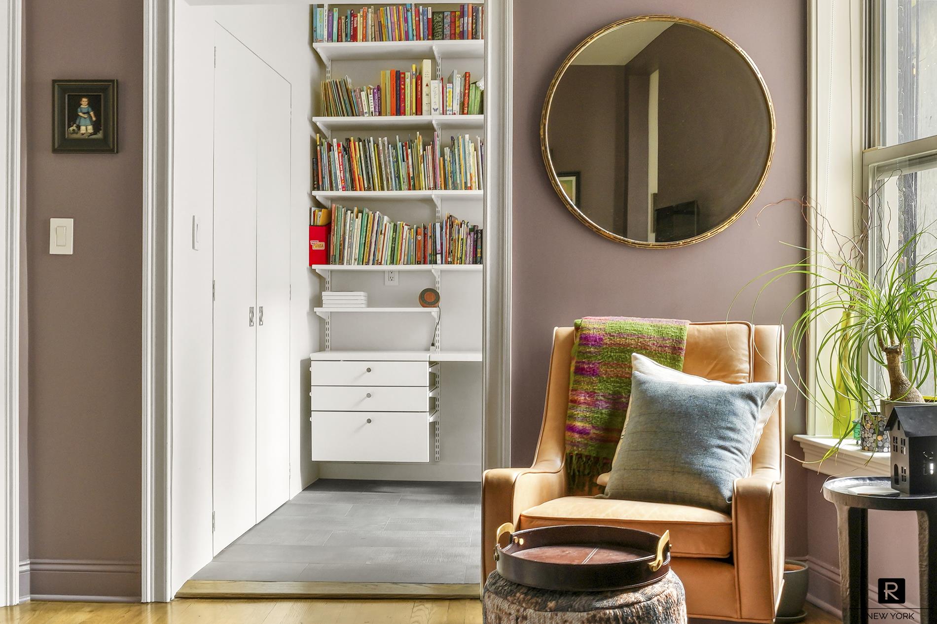 261 West 22nd Street, Unit 24/25/26 Manhattan, NY 10011 - Photo 13 of 22 a living room with furniture and a book shelf