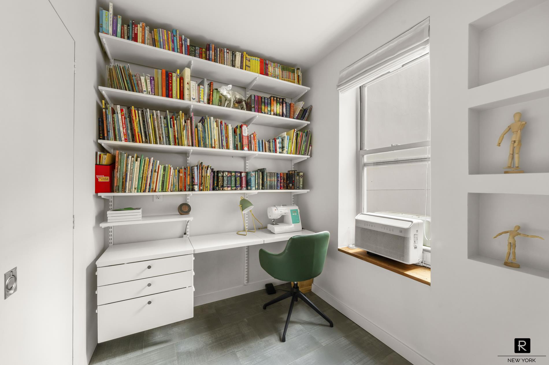 261 West 22nd Street, Unit 24/25/26 Manhattan, NY 10011 - Photo 14 of 22 a room that has a couch chair and a book shelf