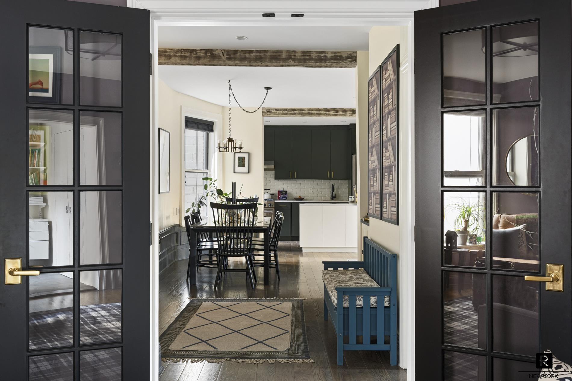 261 West 22nd Street, Unit 24/25/26 Manhattan, NY 10011 - Photo 17 of 22 a dining room with furniture and a floor to ceiling window