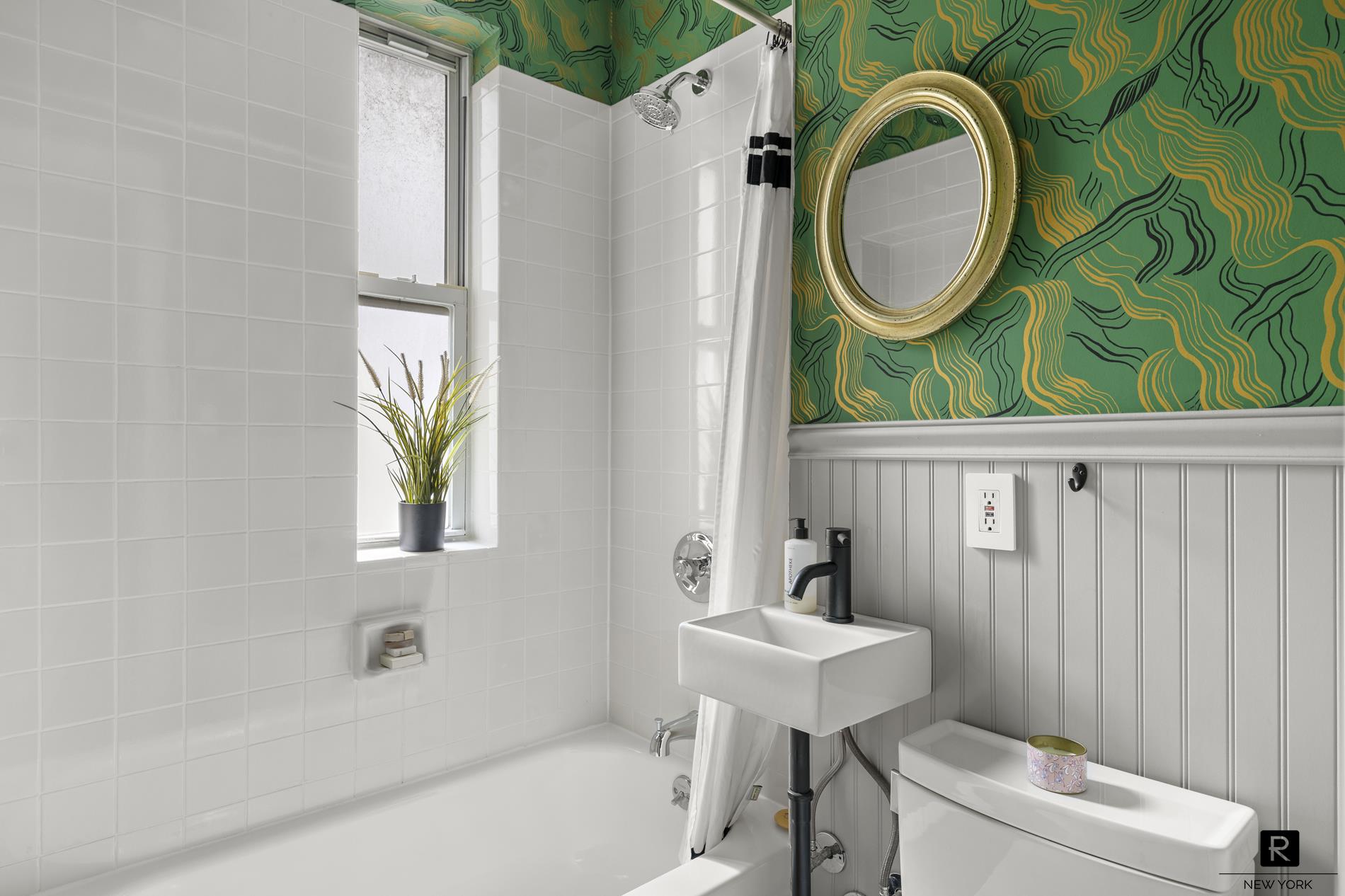 261 West 22nd Street, Unit 24/25/26 Manhattan, NY 10011 - Photo 20 of 22 a bathroom with a sink a toilet and a mirror