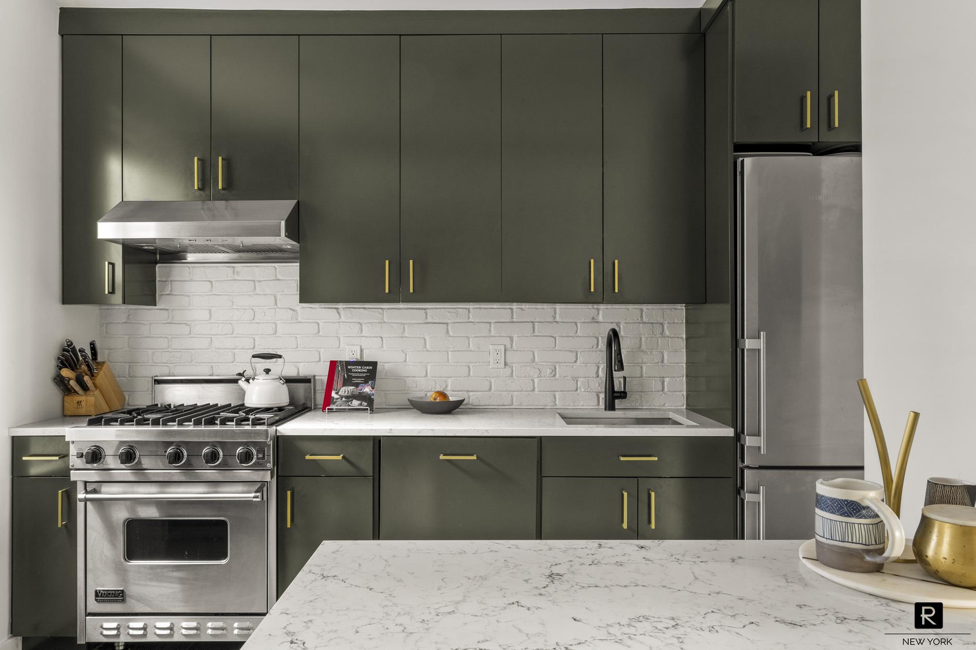 261 West 22nd Street, Unit 24/25/26 Manhattan, NY 10011 - Photo 7 of 22 a kitchen with a sink and a stove top oven