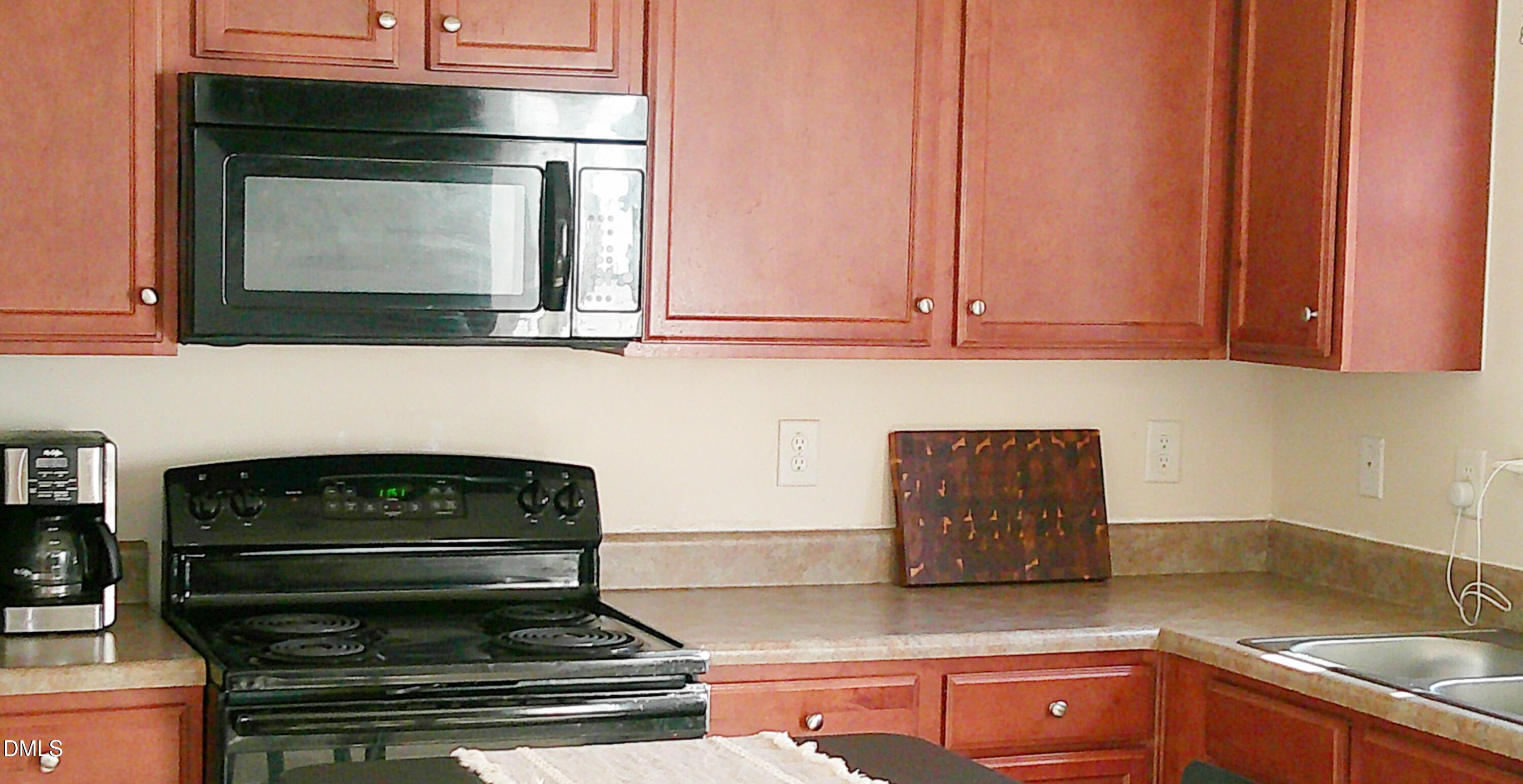 325 Huckleberry Loop Mebane, NC 27302 - Photo 8 of 24 a kitchen with granite countertop stove top oven and cabinets