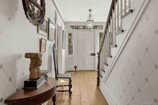 a view of entryway and hall with wooden floor