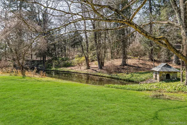a view of yard with swimming pool and trees