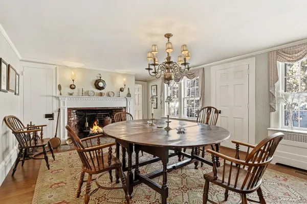 a view of a dining room with furniture and a chandelier
