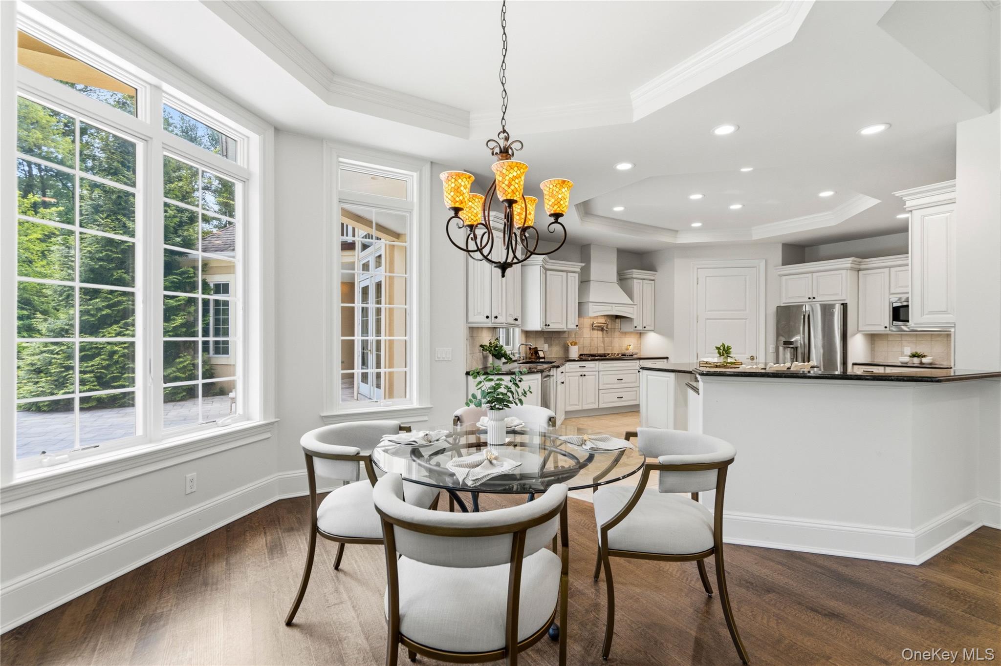 1960 Midlane Road South Syosset, NY 11791 - Photo 20 of 46 a view of a dining room with furniture a chandelier and wooden floor
