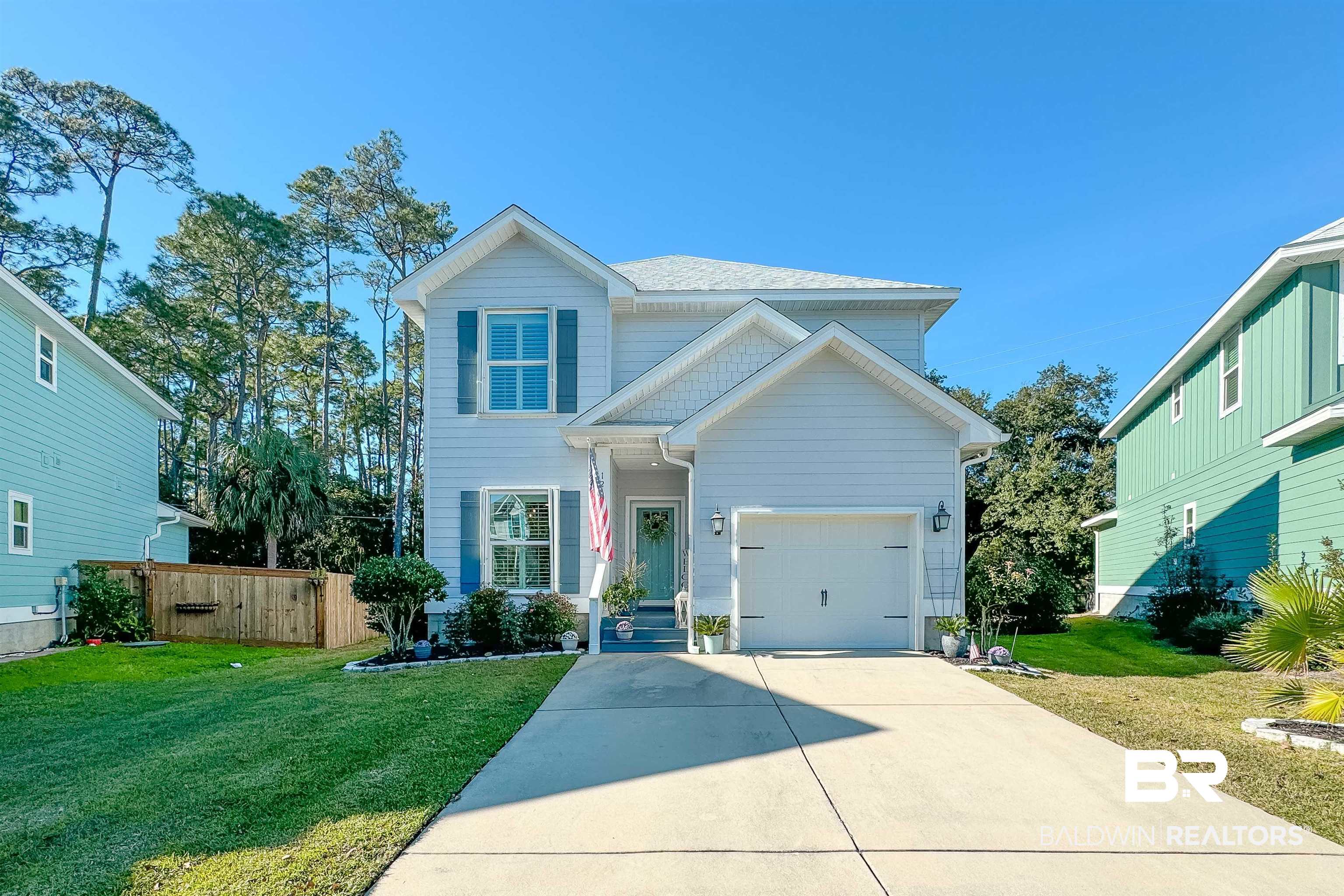 1290 Mako Loop Gulf Shores, AL 36542 - Photo 44 of 50 Traditional home featuring a garage, fence, a front lawn, and concrete driveway