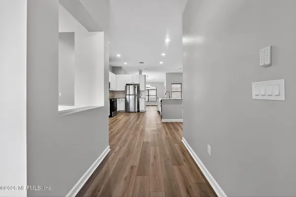 a view of a room with wooden floor