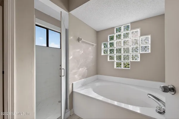 a white bath tub sitting next to a window