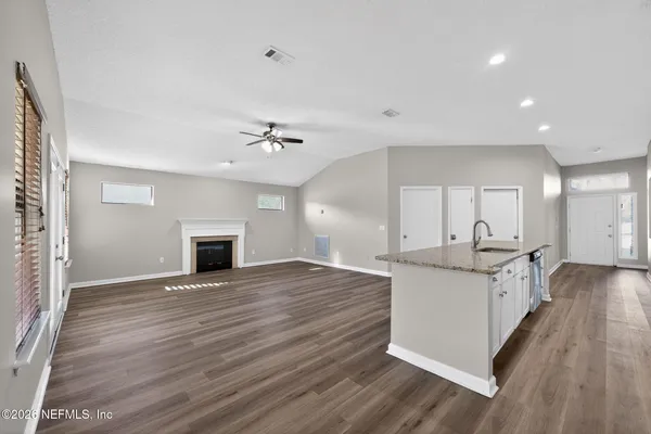 a view of kitchen with sink and wooden floor