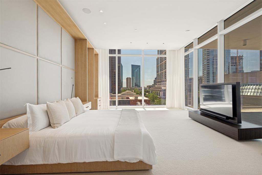 1747 Leonard Street, Unit 403 Dallas, TX 75201 - Photo 1 of 33 a spacious bedroom with a bed and glass door