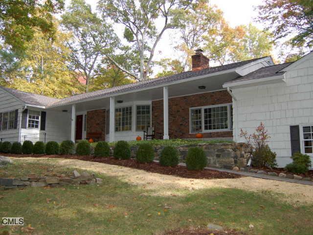 198 Sawmill Road Stamford, CT 06903 - Photo 1 of 1 a front view of a house with garden and porch