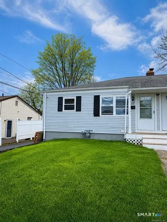 a view of a house with a backyard