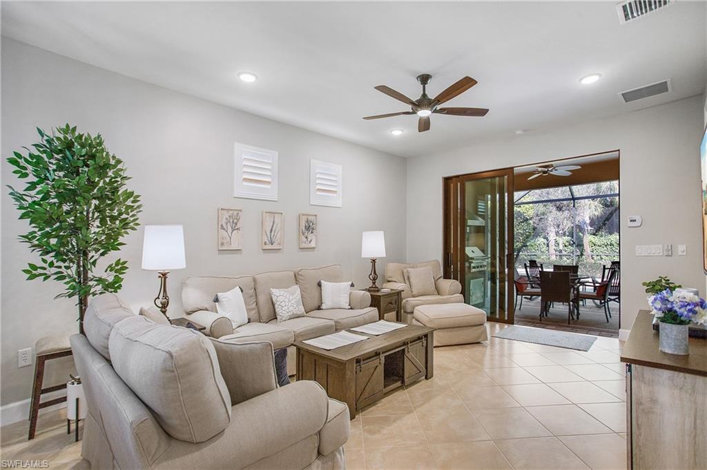 7674 Jacaranda Lane Naples, FL 34114 - Photo 3 of 45 a living room with furniture and a large window