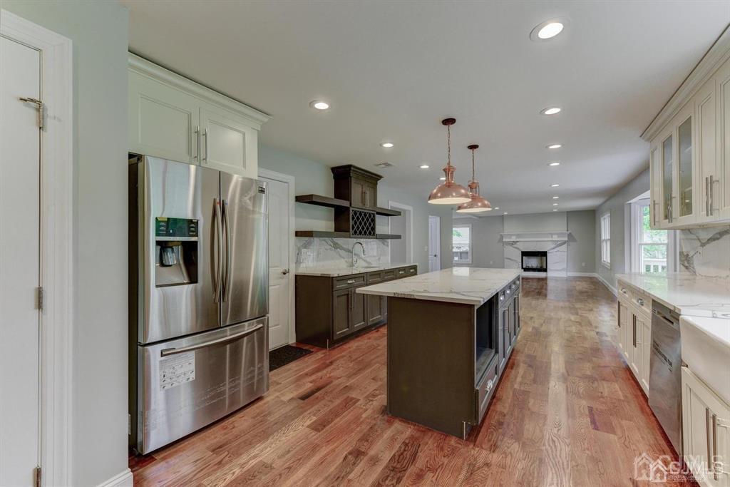 7 Ramsey Road Edison, NJ 08820 - Photo 7 of 28 a kitchen with stainless steel appliances granite countertop a refrigerator a stove a sink dishwasher and a refrigerator with wooden floor