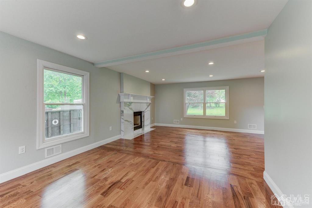 7 Ramsey Road Edison, NJ 08820 - Photo 8 of 28 an empty room with wooden floor and windows