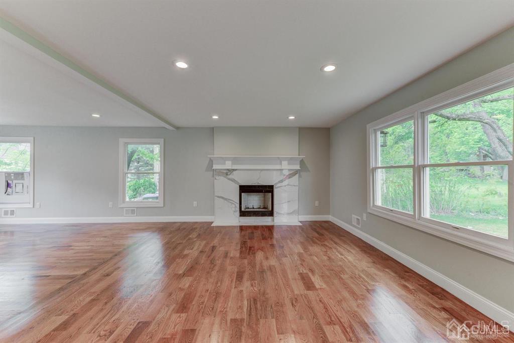 7 Ramsey Road Edison, NJ 08820 - Photo 9 of 28 wooden floor fireplace and windows in an empty room
