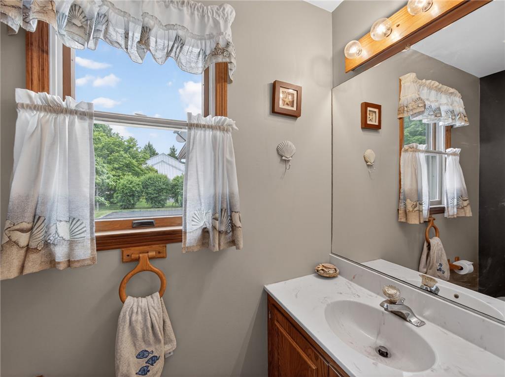 853 Lahr Road Nazareth, PA 18064 - Photo 12 of 29 A well-lit bathroom with a bright window, vanity, and large mirror. Half bath on main floor.