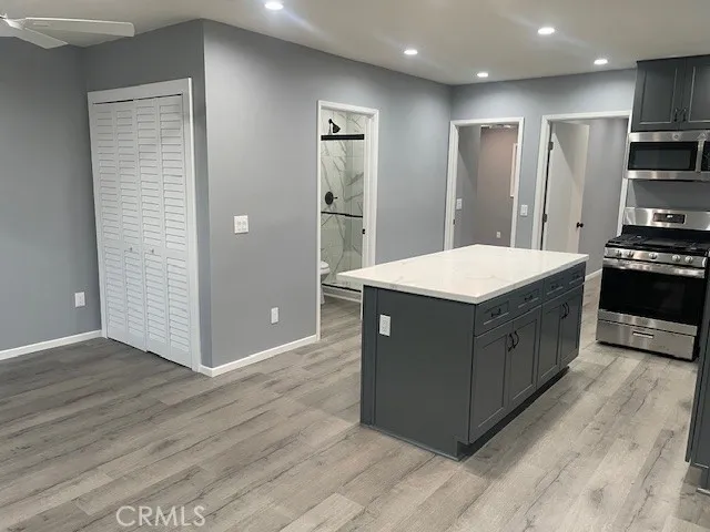 a kitchen with stainless steel appliances granite countertop a wooden floor