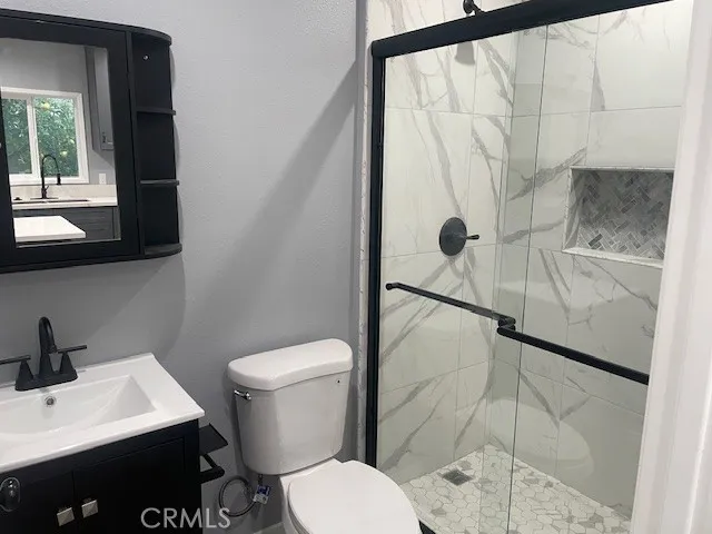 a bathroom with a toilet sink and shower