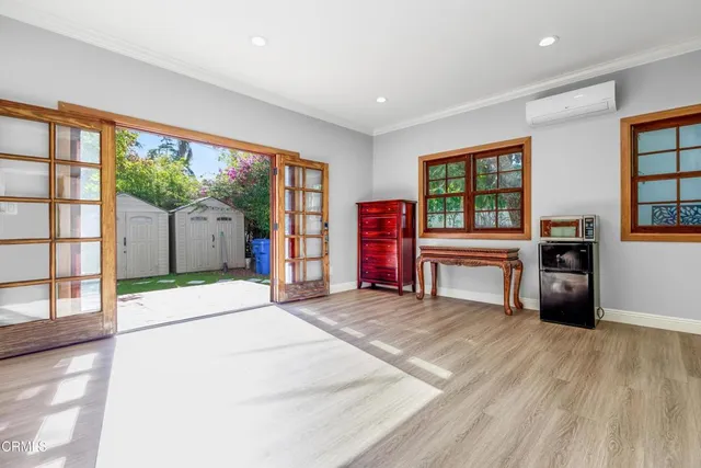 a room with furniture and a floor to ceiling window