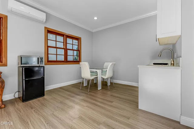 a dining room with furniture and wooden floor