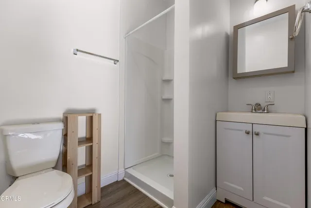 a bathroom with a toilet sink and shower